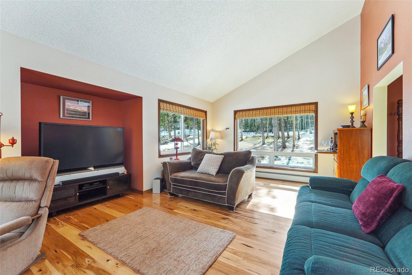 246 Tapadero Road Bailey, CO 80421 - Photo 7 of 50 a living room with furniture and a flat screen tv