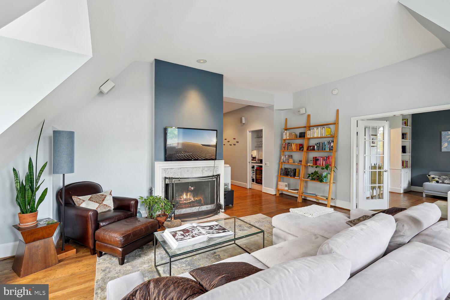 2001 19th Street Northwest, Unit 10 Washington, DC 20009 - Photo 16 of 38 a living room with furniture and a fireplace