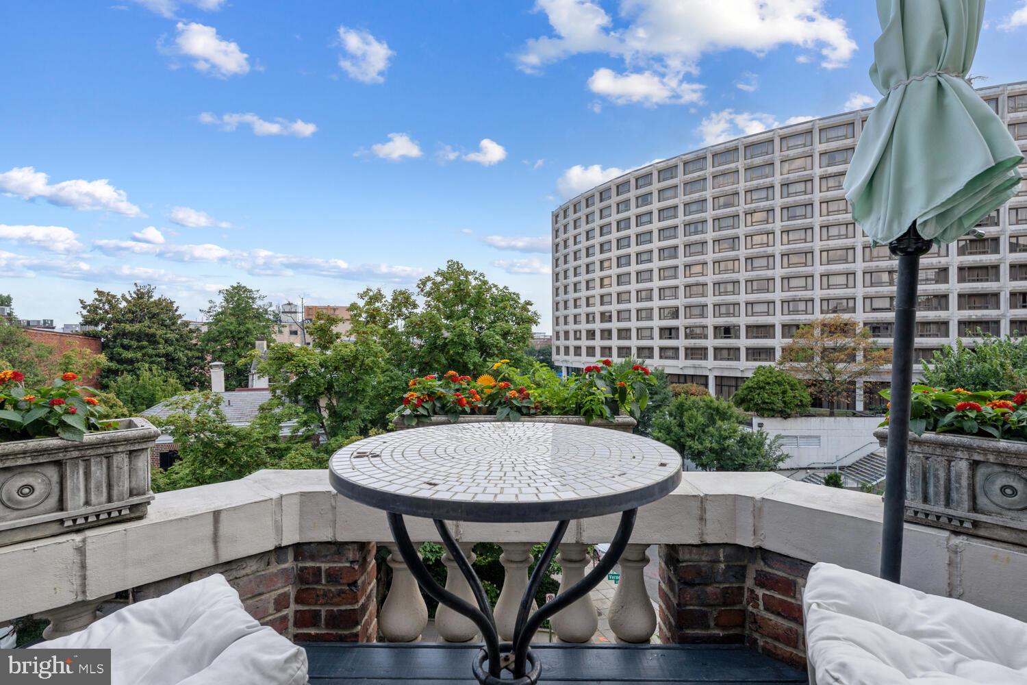 2001 19th Street Northwest, Unit 10 Washington, DC 20009 - Photo 34 of 38 a view of a patio with couches table and chairs and potted plants