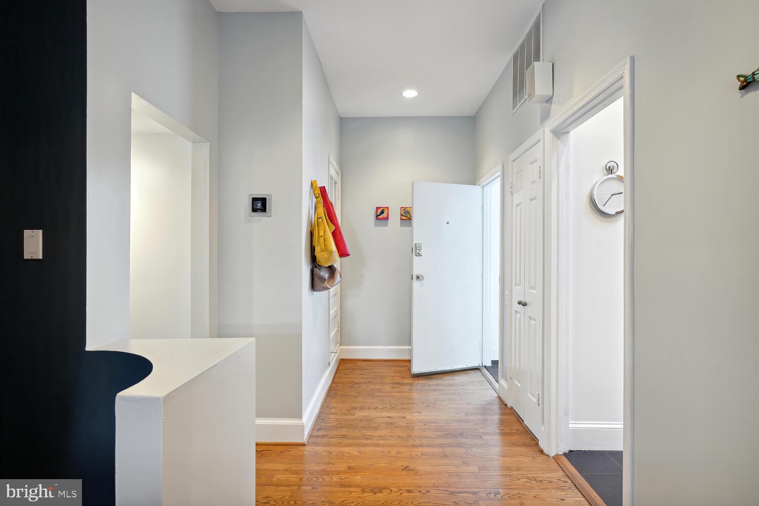 2001 19th Street Northwest, Unit 10 Washington, DC 20009 - Photo 6 of 38 a view of a hallway with wooden floor and entryway
