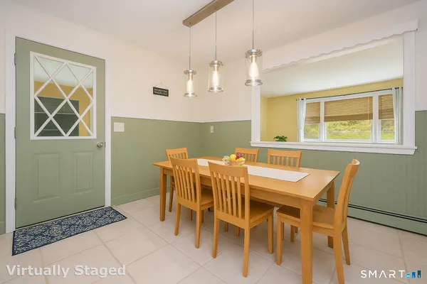 a view of a dining room with furniture and a window
