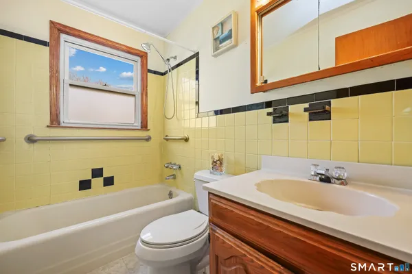 a bathroom with a sink a toilet and a bathtub