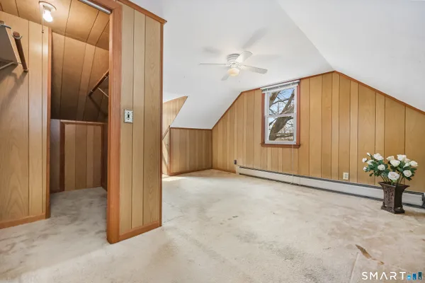 an empty room with closet and a ceiling fan