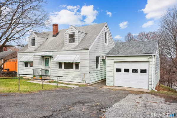 a view of a house with a backyard