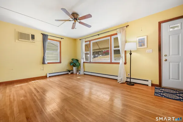 a view of a livingroom with a hardwood floor and a ceiling fan