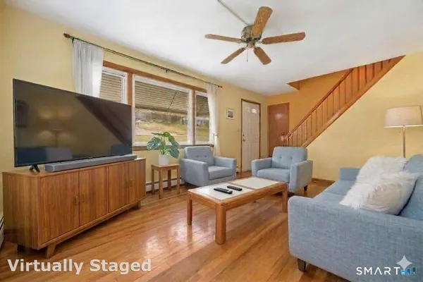 a living room with furniture and a flat screen tv