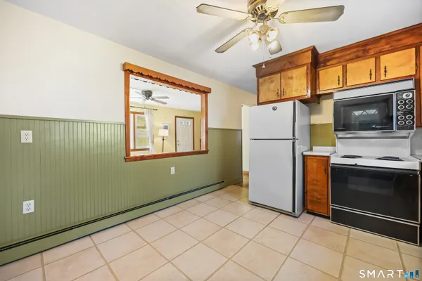 a kitchen with a refrigerator and a stove top oven