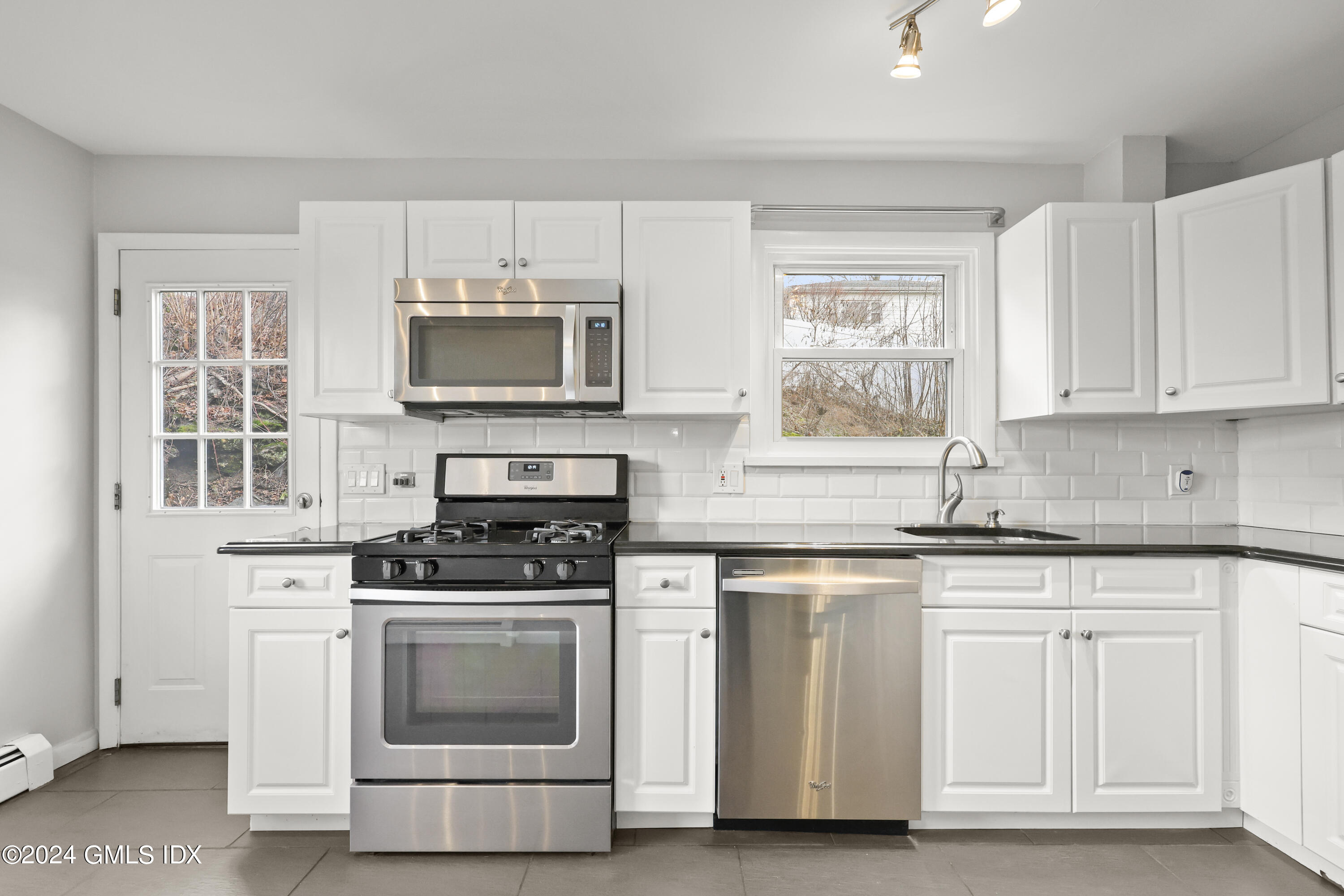 5 Green Lane, Unit A Greenwich, CT 06831 - Photo 13 of 24 a kitchen with granite countertop white cabinets and appliances