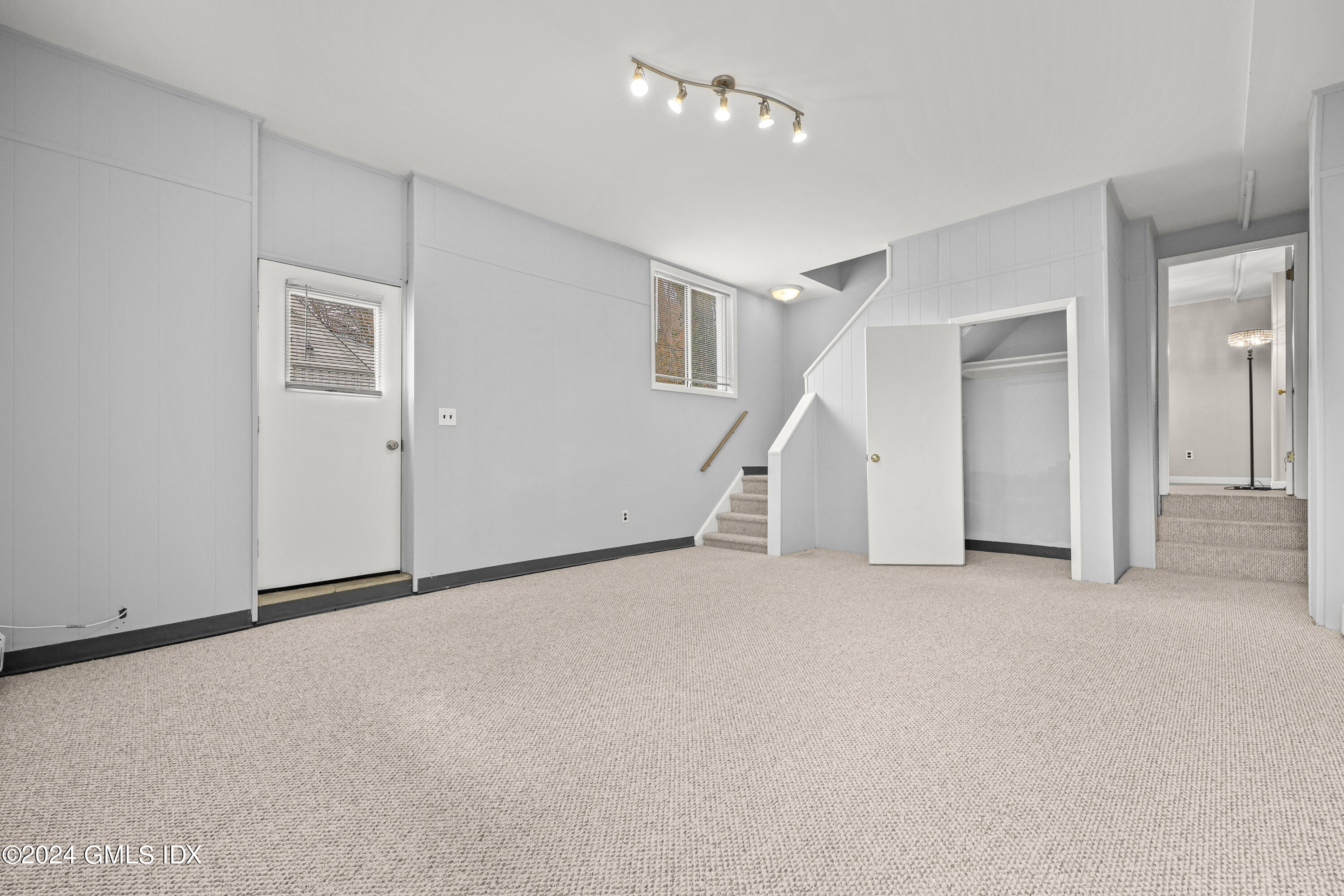 5 Green Lane, Unit A Greenwich, CT 06831 - Photo 19 of 24 an empty room with staircase and white walls