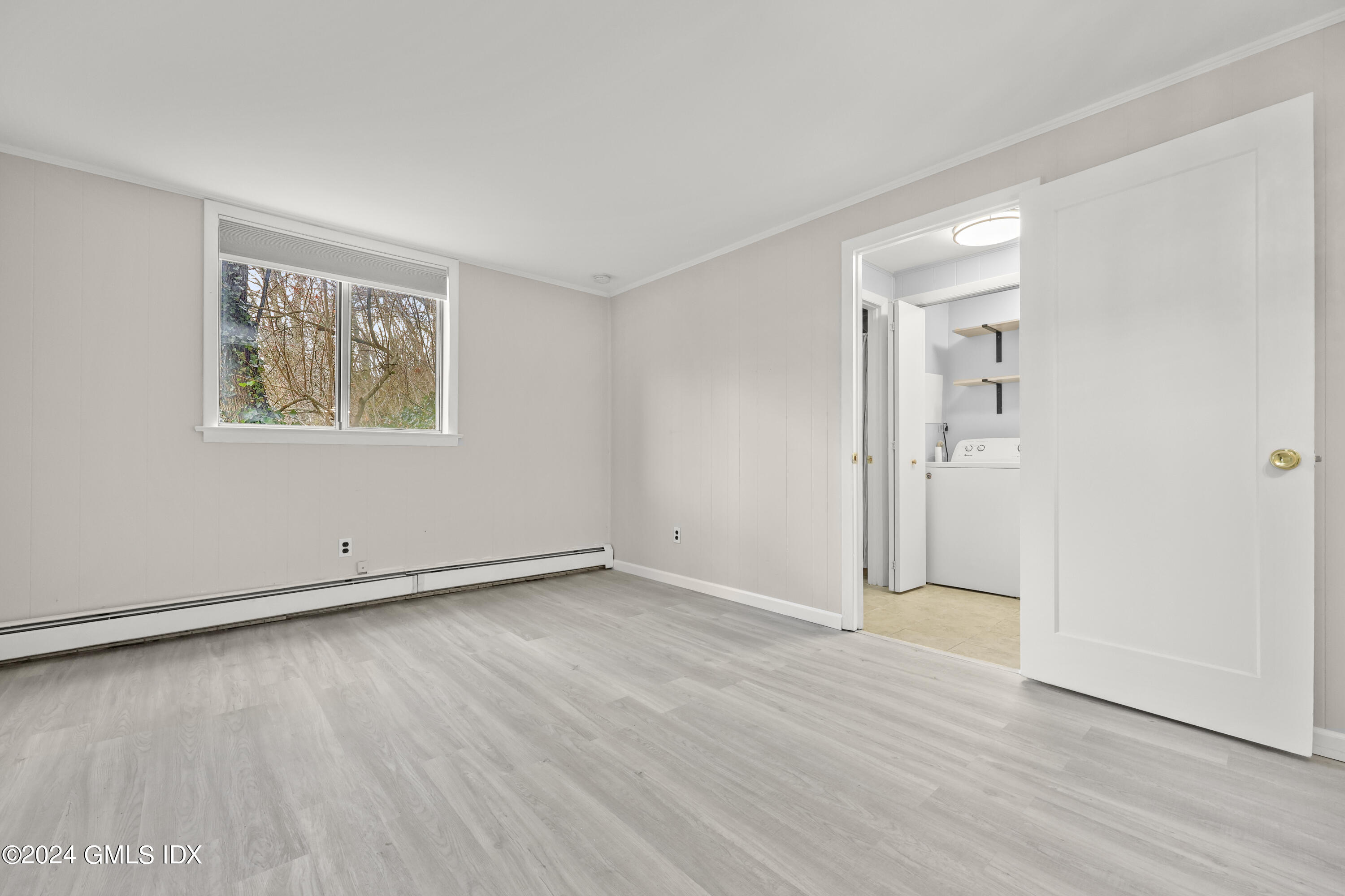 5 Green Lane, Unit A Greenwich, CT 06831 - Photo 20 of 24 an empty room with wooden floor and windows