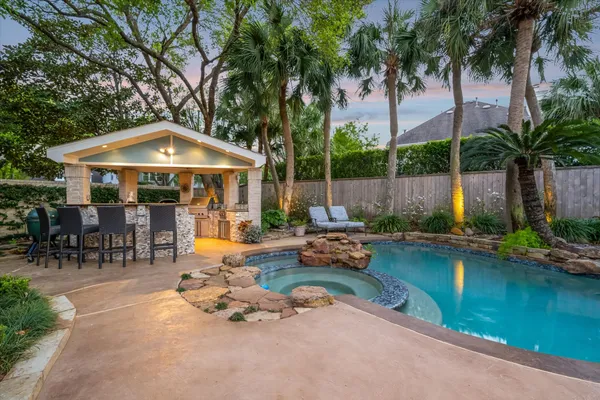 a swimming pool with outdoor seating and yard