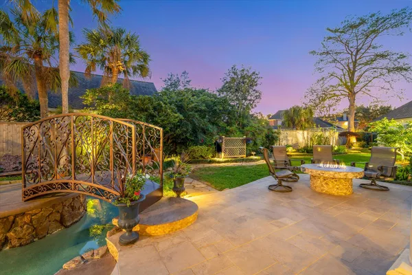 a backyard of a house with table and chairs