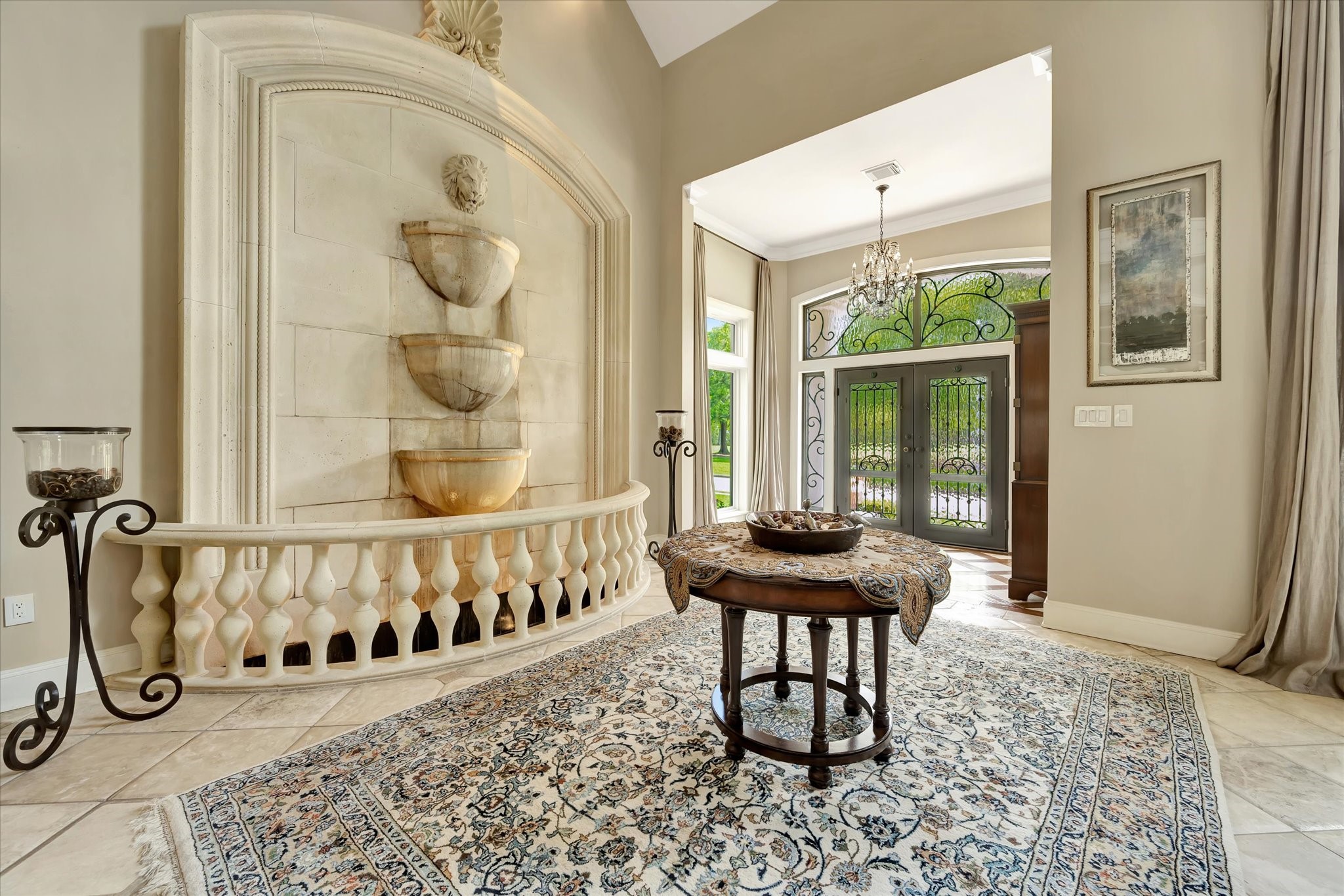 14214 Golf View Trail Houston, TX 77059 - Photo 24 of 49 Elegant entryway featuring a grand indoor fountain with tiered bowls, ornate double doors with decorative ironwork, and a classic chandelier.