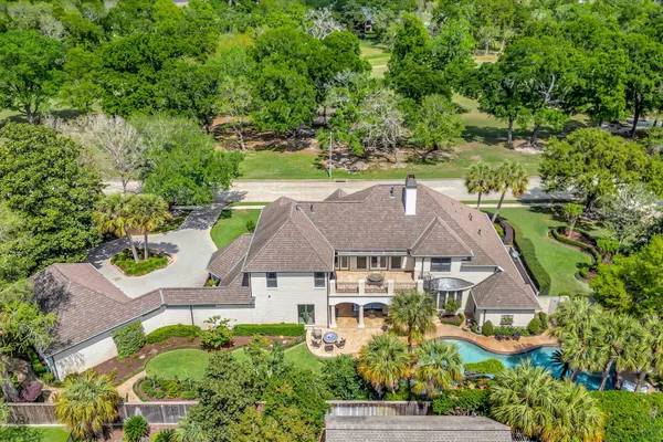 an aerial view of a house with yard swimming pool and outdoor seating
