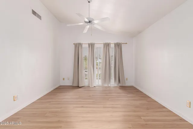 a view of a room with wooden floor