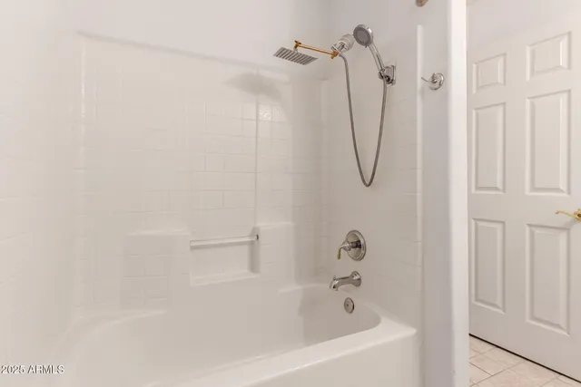 a bathroom with a bath tub with a shower