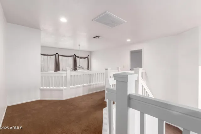 a view of a livingroom with furniture and hardwood floor