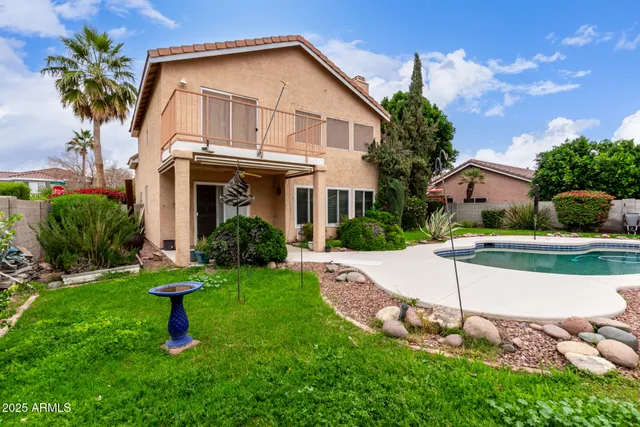 a view of a house with backyard and sitting area