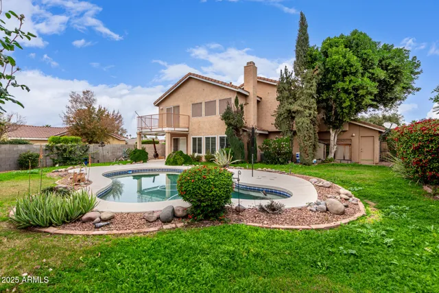 a swimming pool with outdoor seating and yard