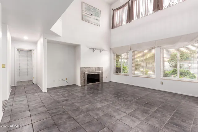 a view of an empty room with a fireplace and a window