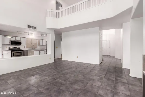 a view of a kitchen with a sink and a refrigerator