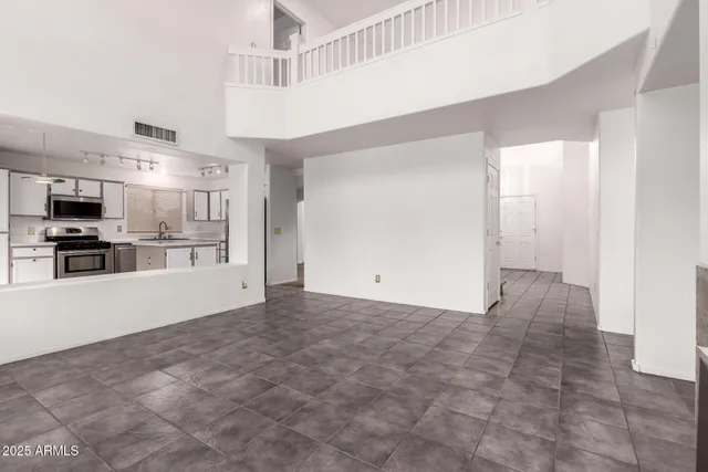 a view of a kitchen with a sink and a refrigerator