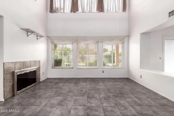 a view of empty room with window and fireplace