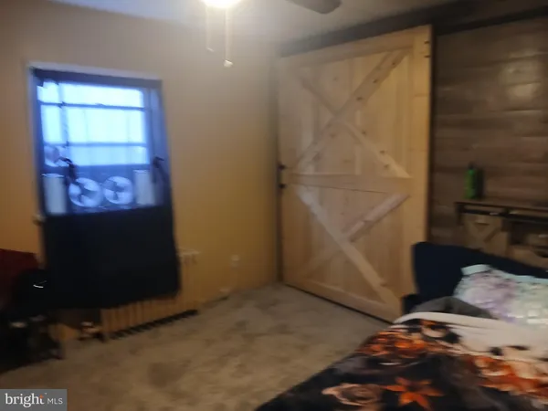 a bed sitting in a bedroom next to a bathroom