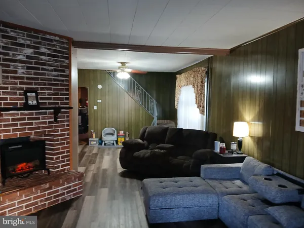 a living room with furniture and a fireplace