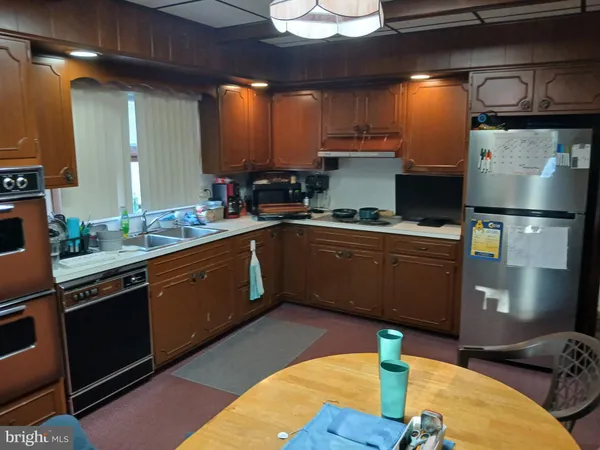 a kitchen with stainless steel appliances granite countertop a sink dishwasher stove and cabinets