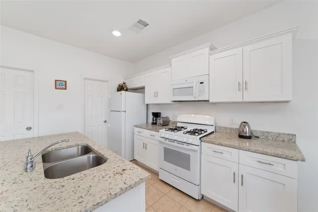 a living room with furniture a dining table and chairs