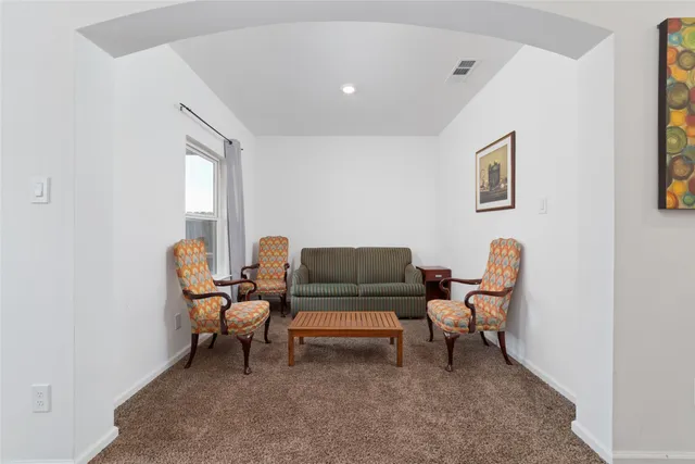 a living room with furniture and a chair