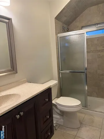 a bathroom with a granite countertop sink toilet and a shower