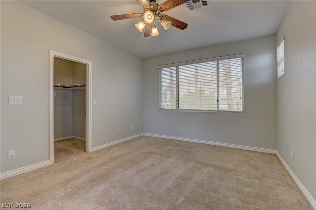 1813 Snow Spring Lane Las Vegas, NV 89134 - Photo 23 of 37 A well-lit bedroom offering plush carpeted floors and a convenient walk-in closet.