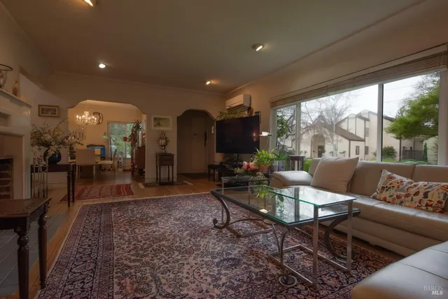 a living room with furniture and a floor to ceiling window