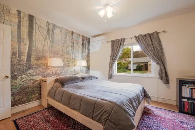 a bedroom with a bed and a window