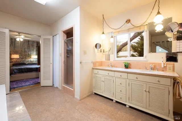 a spacious bathroom with a sink and a mirror