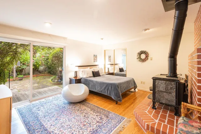 a spacious bedroom with a bed and glass windows