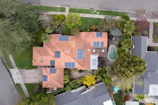 an aerial view of residential houses with outdoor space and street view