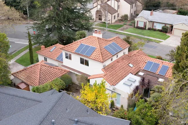 an aerial view of a house with a yard and garden