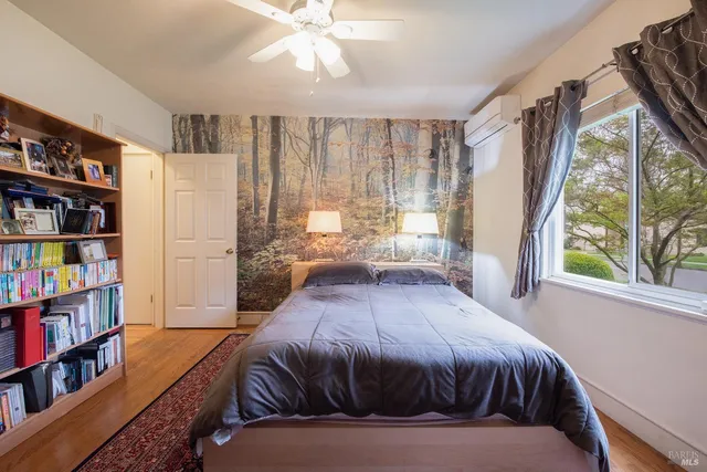 a bedroom with a large bed and a book shelf