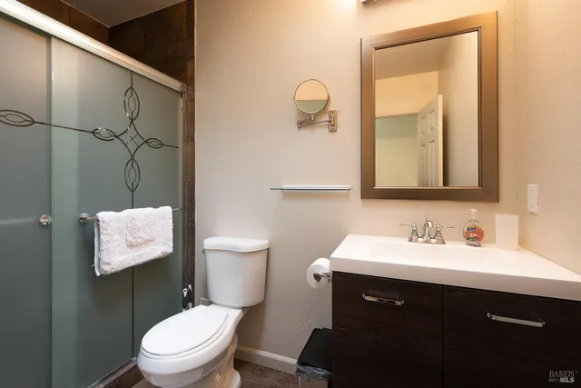 a bathroom with a toilet sink and mirror