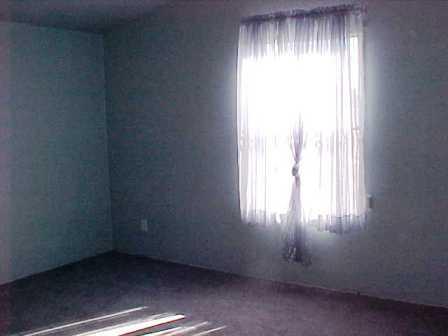 14741 Douglas Road Yakima, WA 98908 - Photo 4 of 18 an empty room with a empty space and windows