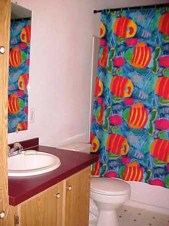 14741 Douglas Road Yakima, WA 98908 - Photo 5 of 18 a bathroom with a sink that has a toilet and a curtain