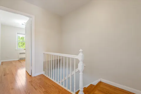 a view of hallway with wooden floor