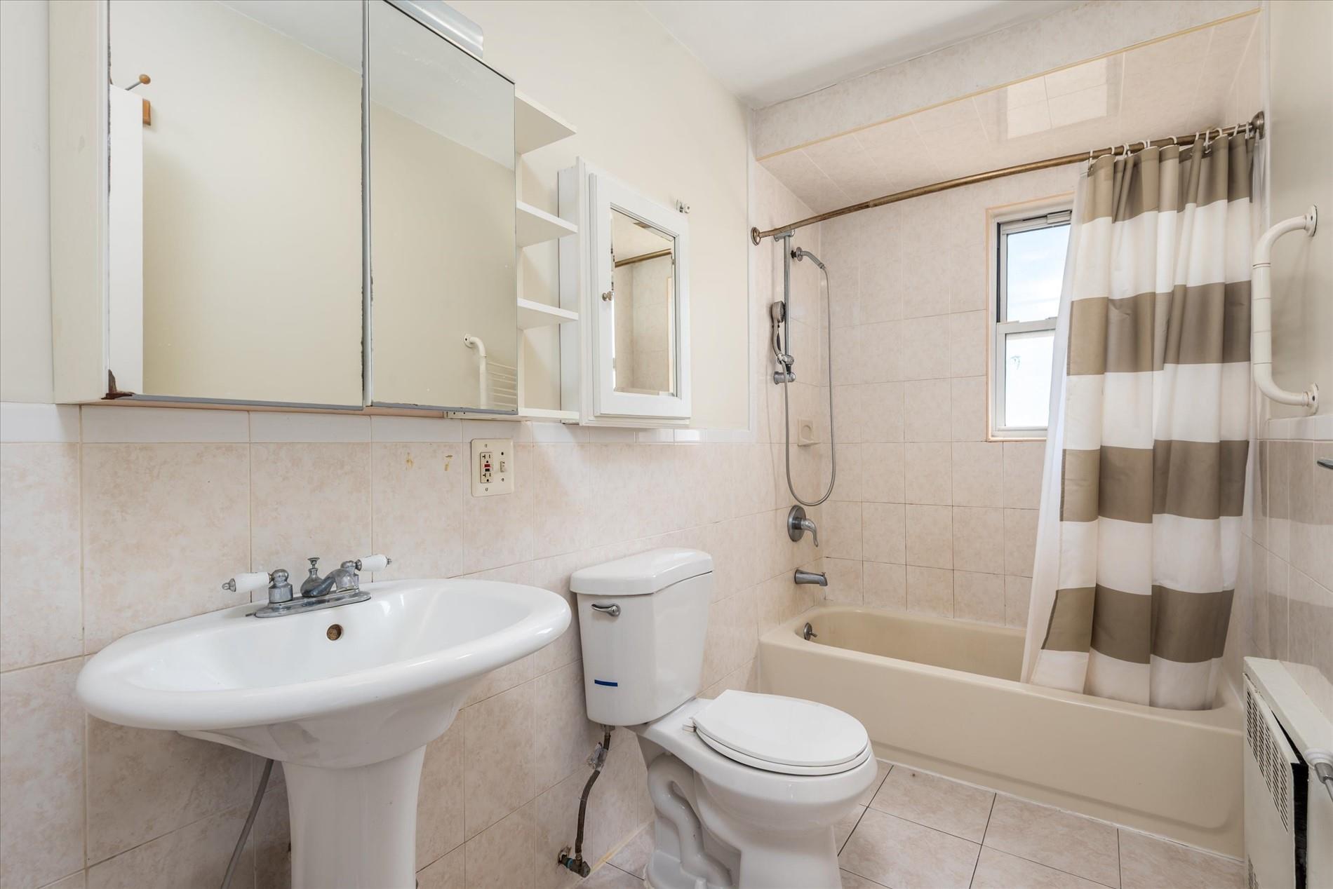 150-20 77th Avenue Queens, NY 11367 - Photo 12 of 24 a bathroom with a sink toilet and shower