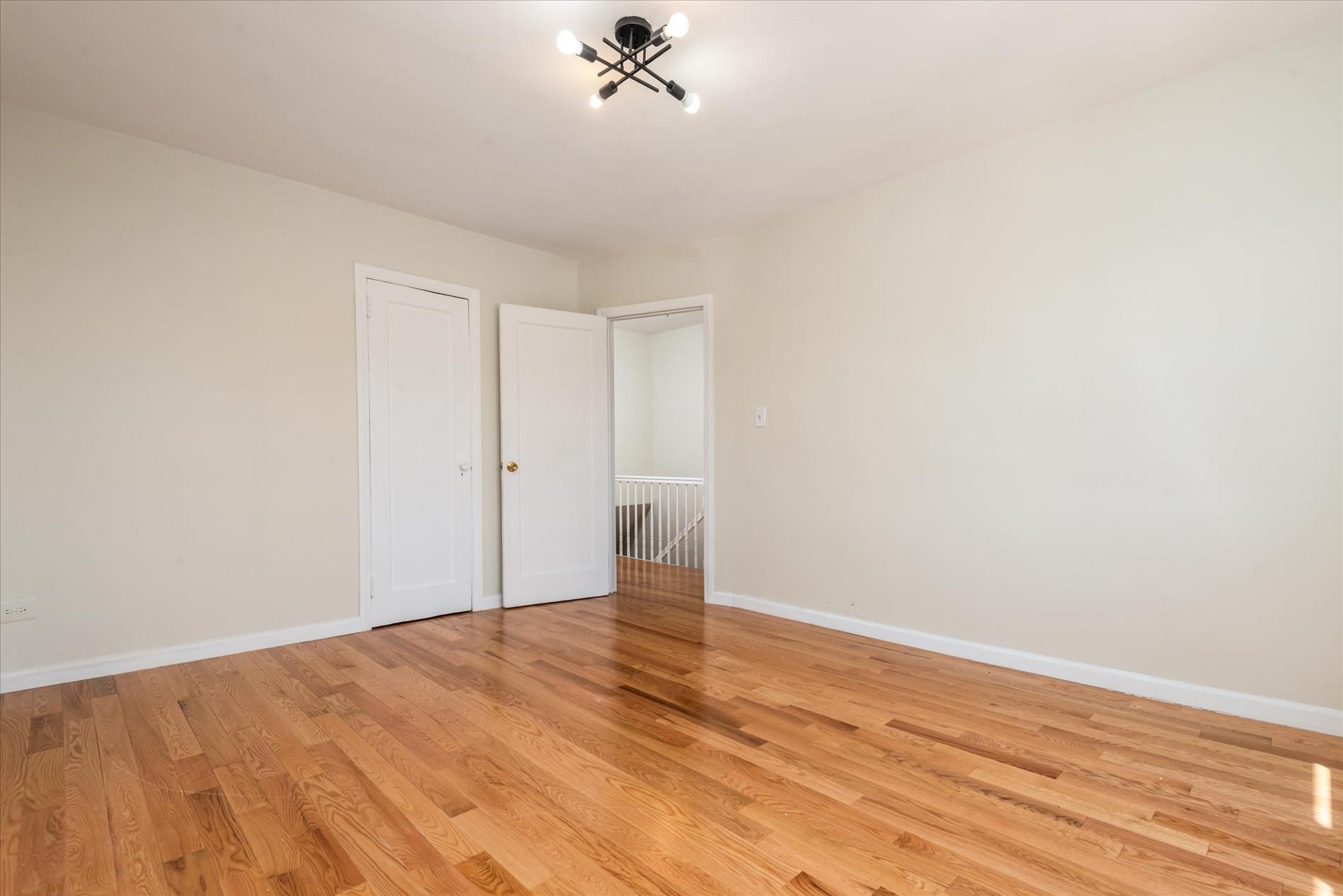 150-20 77th Avenue Queens, NY 11367 - Photo 15 of 24 a view of empty room with wooden floor