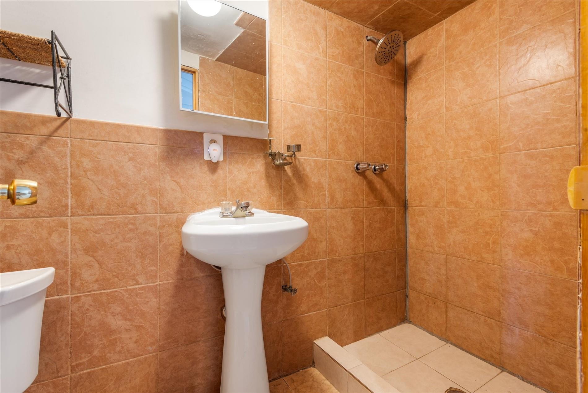 150-20 77th Avenue Queens, NY 11367 - Photo 20 of 24 a bathroom with a sink a toilet and shower