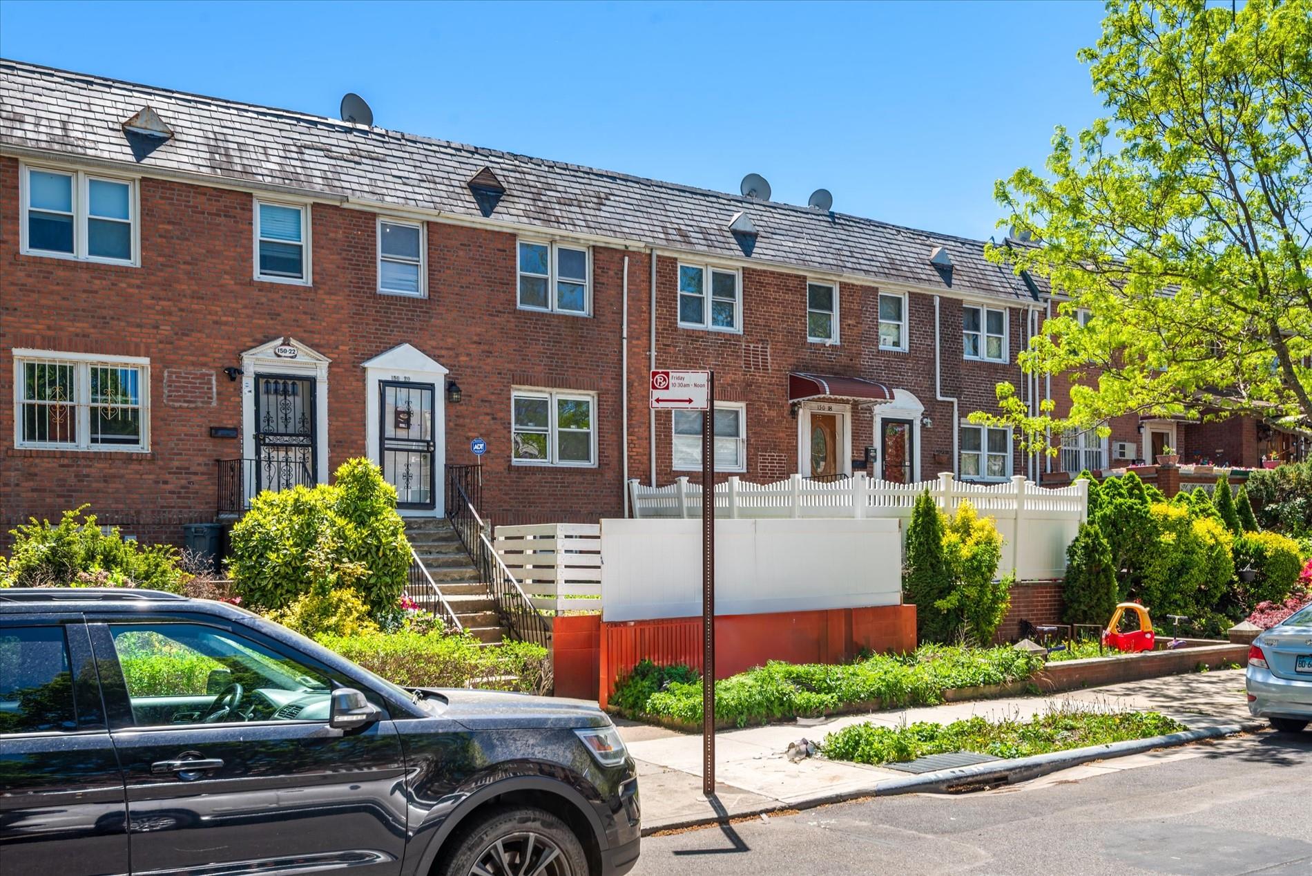 150-20 77th Avenue Queens, NY 11367 - Photo 2 of 24 a front view of a house with a yard