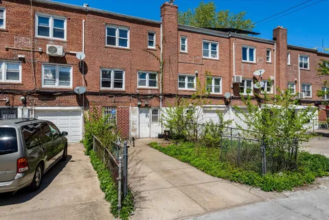 a view of a car park in front of a brick building